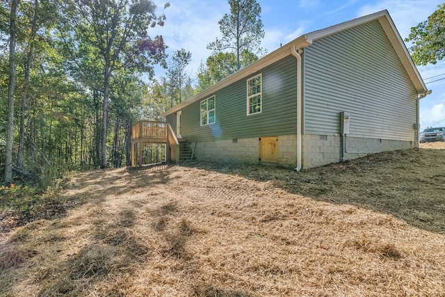 view of side of home featuring a deck