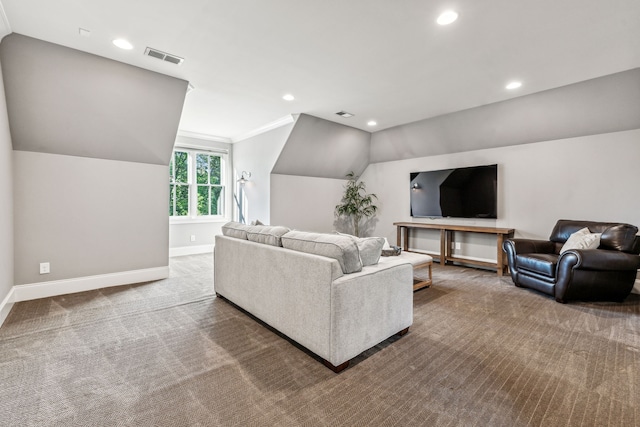 living room with lofted ceiling, ornamental molding, and carpet