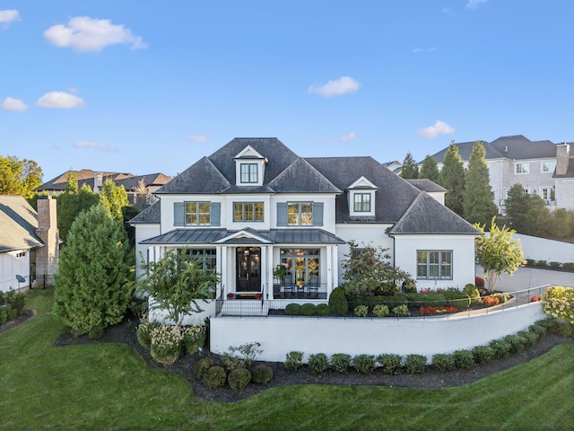 view of front of property featuring a porch and a front lawn