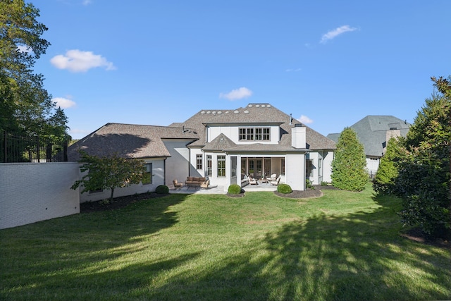 back of house featuring a yard and a patio