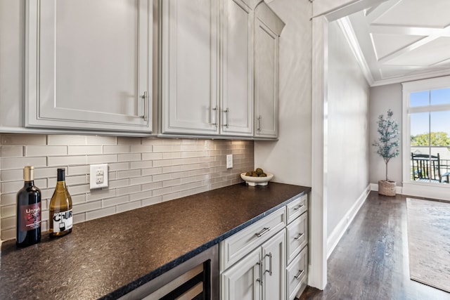 kitchen featuring decorative backsplash, white cabinets, beverage cooler, dark hardwood / wood-style flooring, and dark stone counters