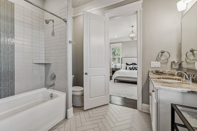 full bathroom with vanity, tiled shower / bath combo, and toilet