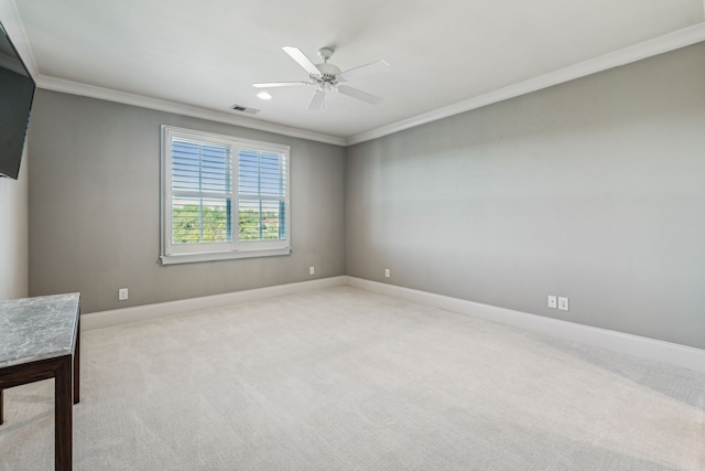 carpeted empty room with crown molding and ceiling fan