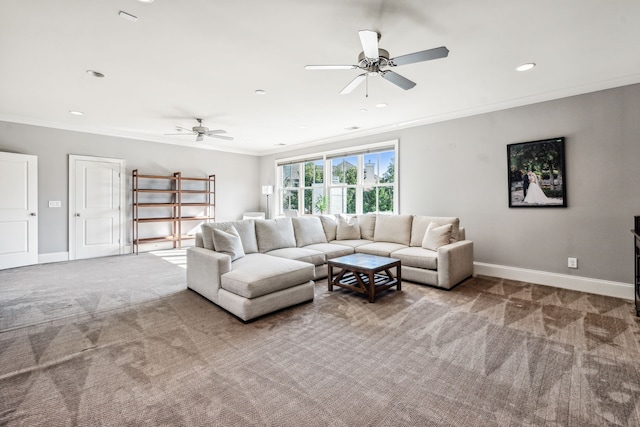 carpeted living room with ornamental molding and ceiling fan