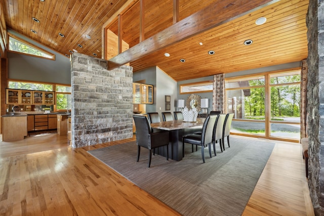 dining space with wood ceiling, high vaulted ceiling, and light hardwood / wood-style floors