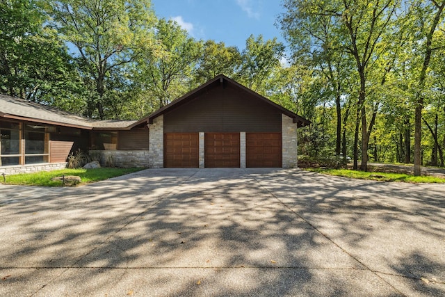 109 Jocelyn Hills Dr, Nashville, TN 37205 - view of side of home with a garage, stone siding, and concrete driveway