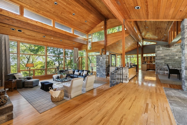 living room featuring wood-type flooring, high vaulted ceiling, wooden ceiling, beamed ceiling, and a fireplace