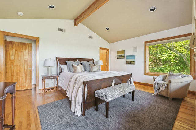 bedroom with hardwood / wood-style flooring and vaulted ceiling with beams