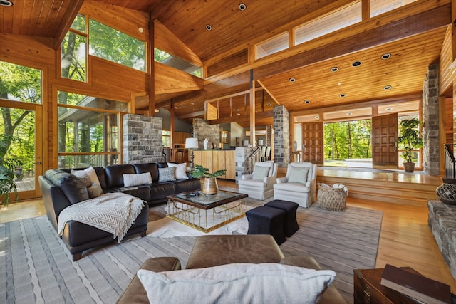 living room with wood ceiling, high vaulted ceiling, and light hardwood / wood-style flooring