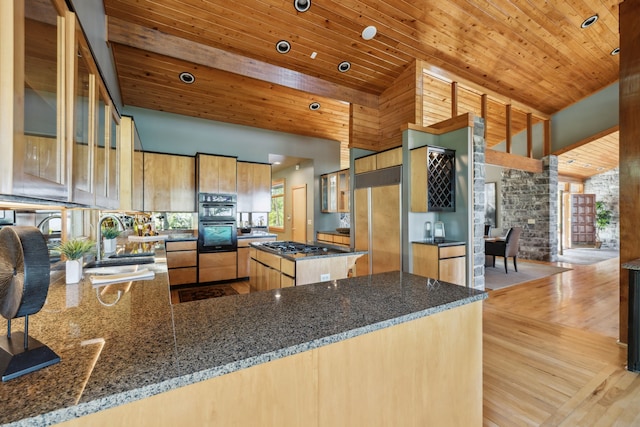 kitchen with sink, high vaulted ceiling, wooden ceiling, paneled refrigerator, and kitchen peninsula