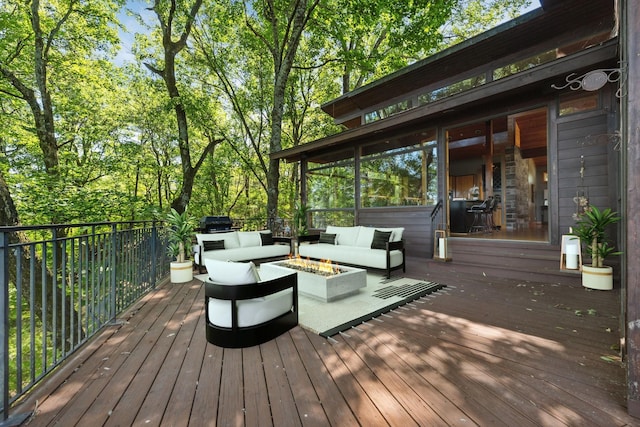 deck with an outdoor living space with a fire pit