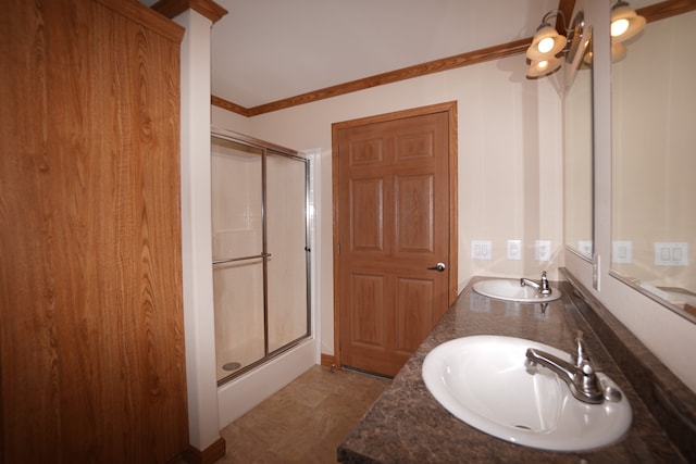 bathroom with crown molding, vanity, and a shower with door