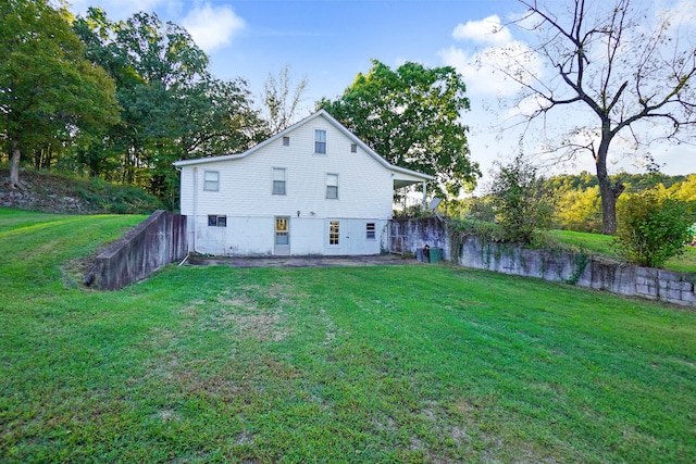 back of property with a lawn