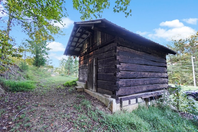 view of side of home featuring a storage unit