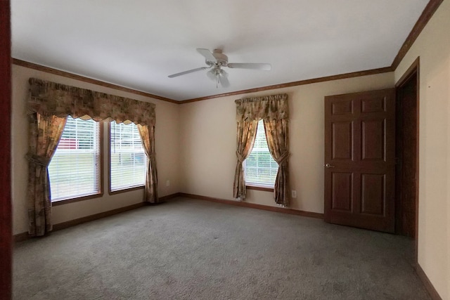 carpeted spare room featuring crown molding, plenty of natural light, and ceiling fan