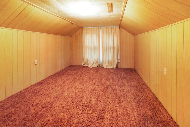 bonus room featuring carpet floors, vaulted ceiling, and wooden walls