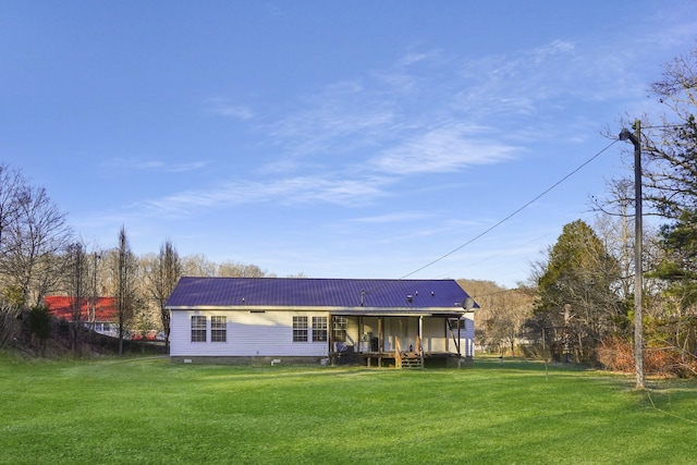 back of property featuring a yard and covered porch