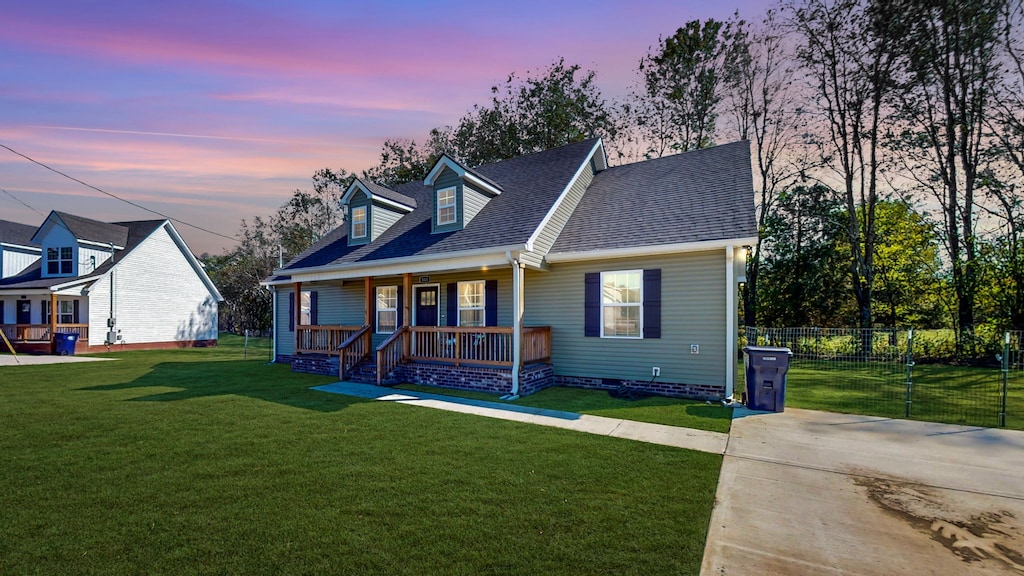 view of front of property featuring a yard and a porch