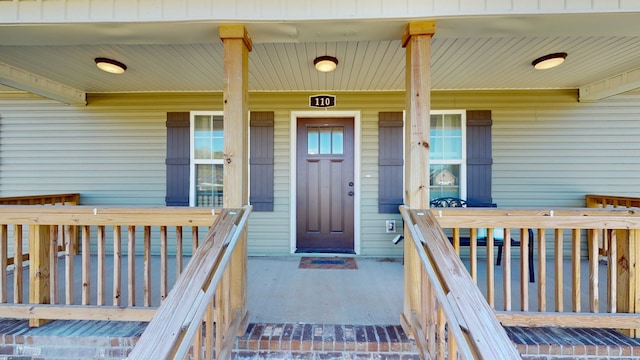 doorway to property featuring covered porch