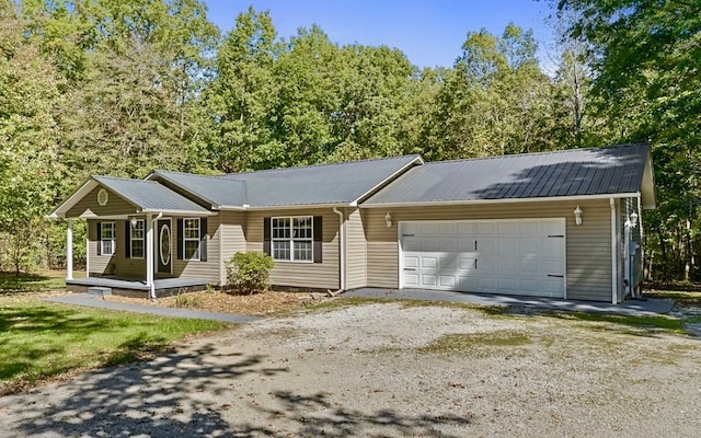 ranch-style home with covered porch and a garage