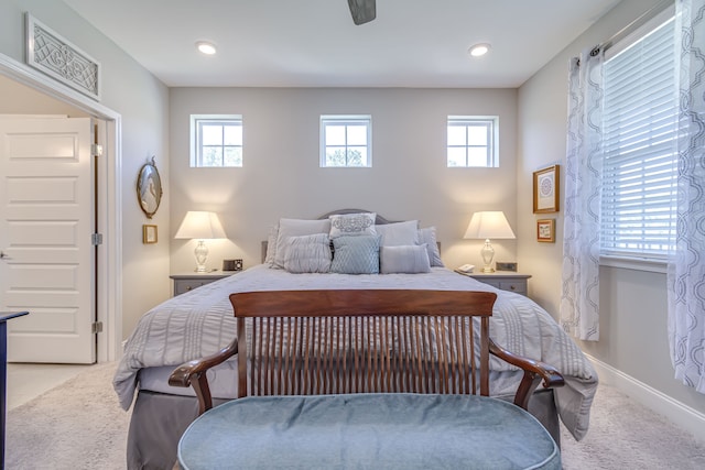 bedroom with ceiling fan and light carpet