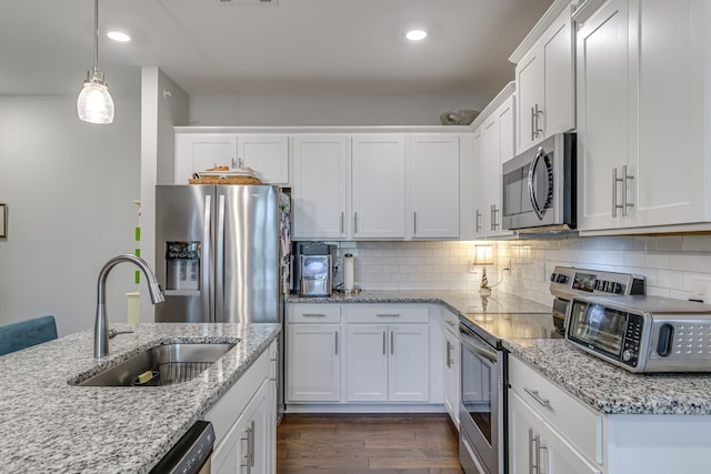 kitchen featuring white cabinets, stainless steel appliances, and dark hardwood / wood-style flooring