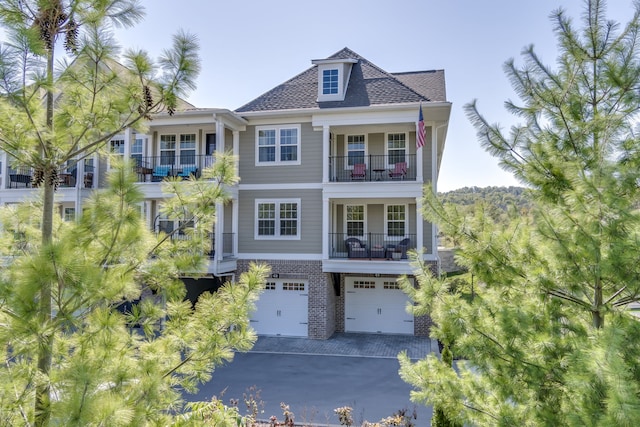 view of front of house with a garage and a balcony