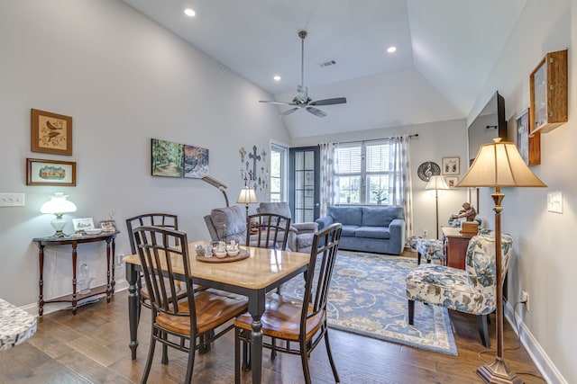 dining room with ceiling fan, dark wood-type flooring, and high vaulted ceiling