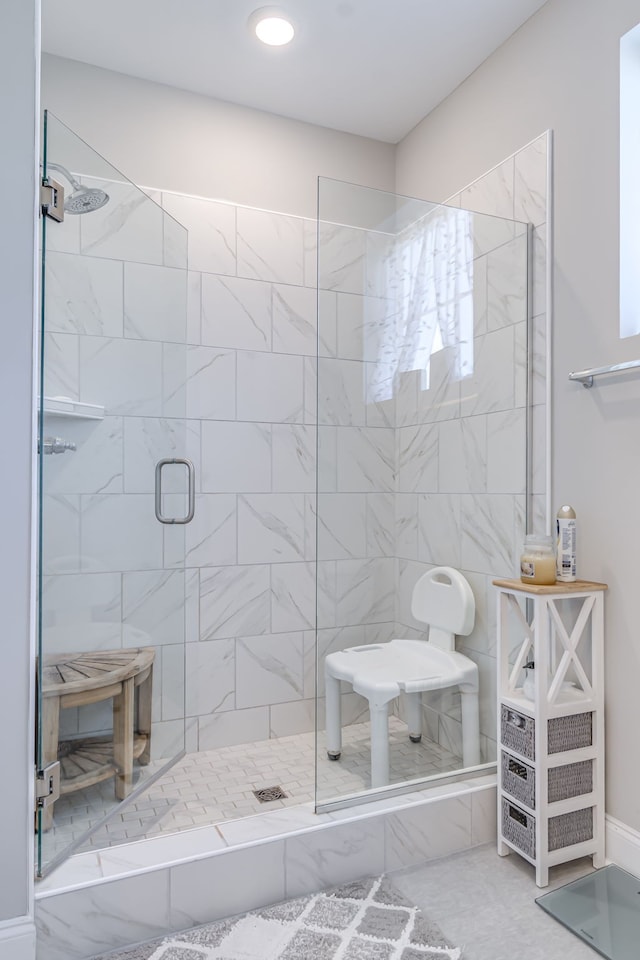 bathroom with walk in shower and tile patterned floors