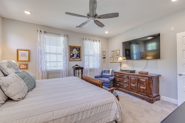 bedroom featuring light carpet and ceiling fan