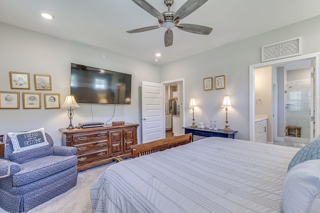 carpeted bedroom with ceiling fan and connected bathroom