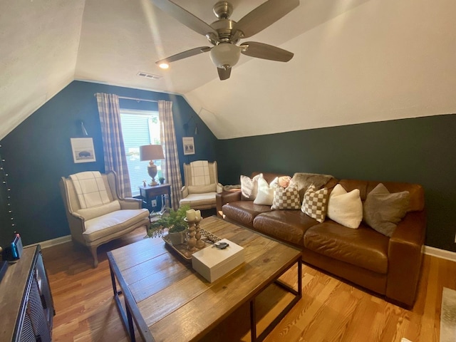 living room with vaulted ceiling, hardwood / wood-style flooring, and ceiling fan