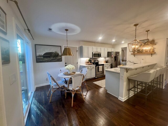 dining area featuring a chandelier and dark hardwood / wood-style floors