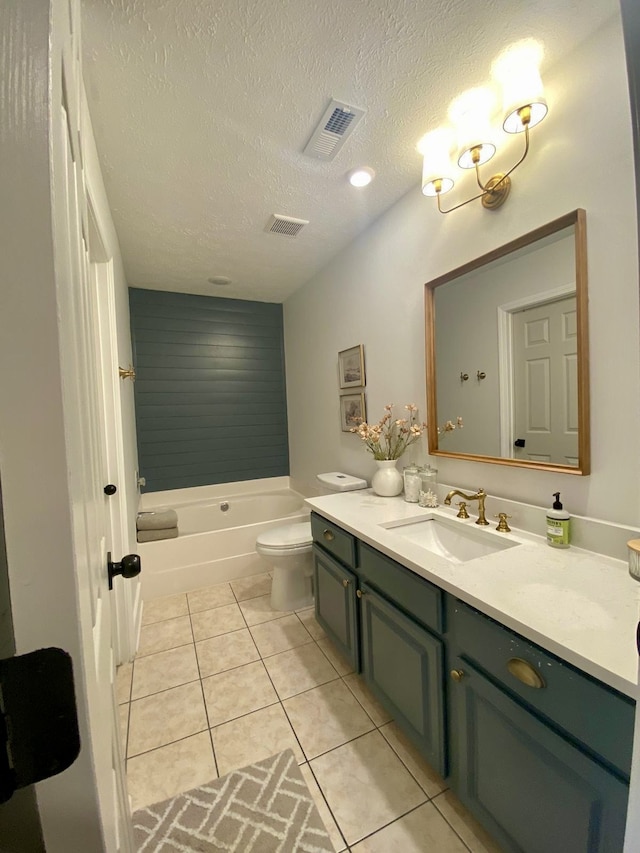 bathroom featuring vanity, a textured ceiling, tile patterned floors, and toilet