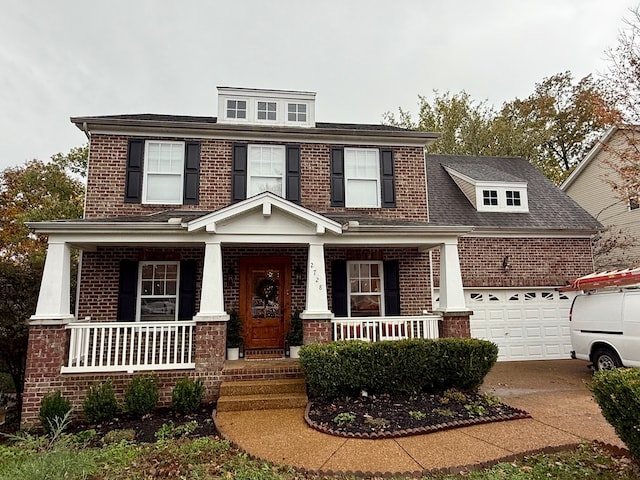 view of front of home with a garage and a porch