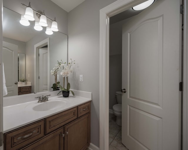 bathroom featuring toilet, tile patterned flooring, and vanity