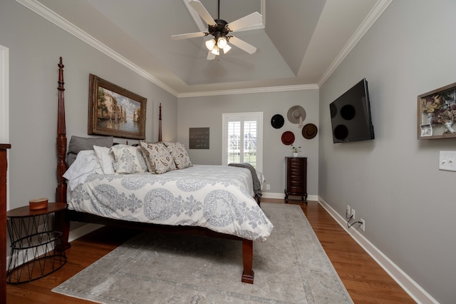 bedroom with ornamental molding, hardwood / wood-style flooring, and ceiling fan