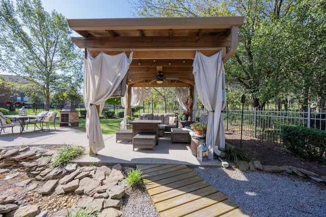 view of patio featuring an outdoor living space, a gazebo, and ceiling fan