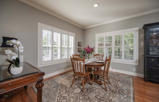 dining room featuring wood-type flooring and crown molding