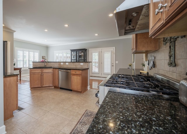 kitchen featuring decorative backsplash, stainless steel dishwasher, dark stone counters, crown molding, and light tile patterned floors