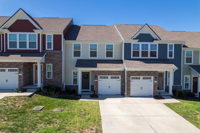 view of front of property with a front yard and a garage