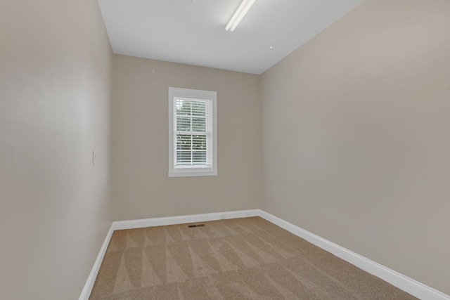 unfurnished room featuring light colored carpet