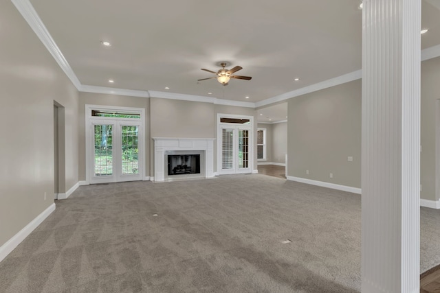 unfurnished living room featuring light carpet, ornamental molding, and ceiling fan