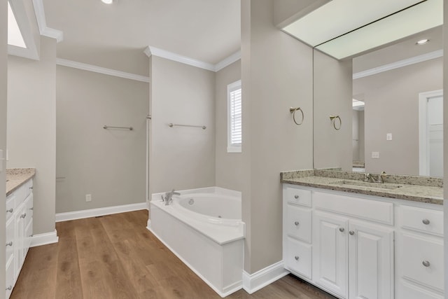 bathroom with a bathtub, crown molding, hardwood / wood-style floors, and vanity