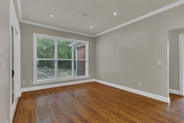 spare room with crown molding and hardwood / wood-style floors