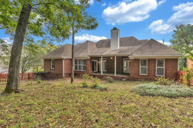 rear view of house with a lawn and a patio area