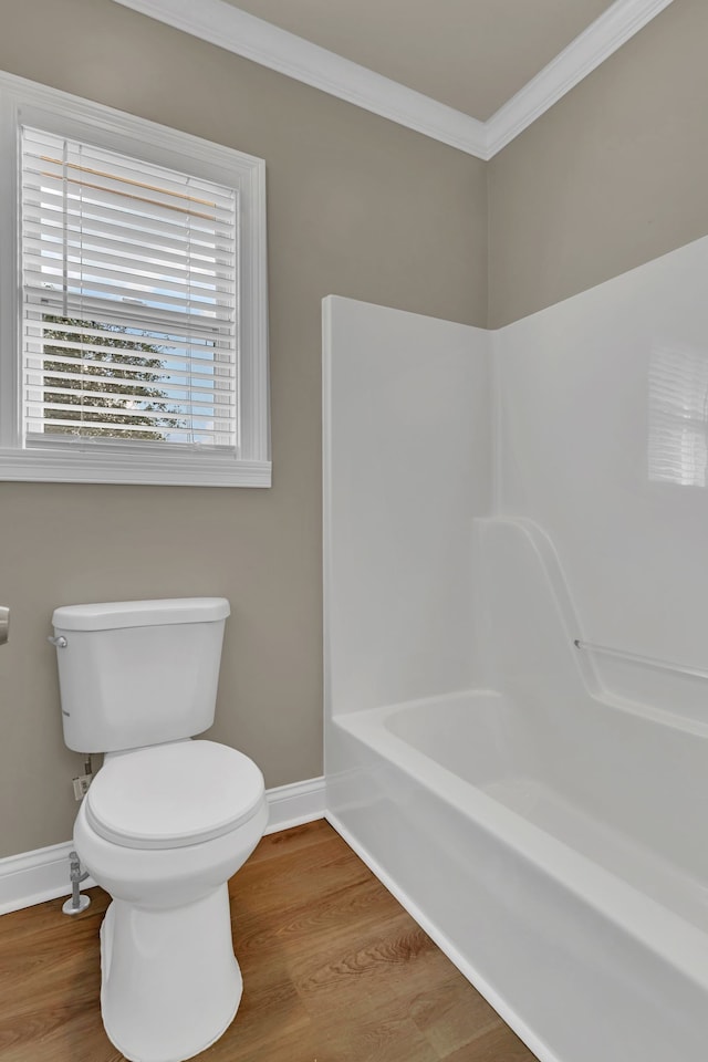 bathroom with hardwood / wood-style floors, toilet, and crown molding