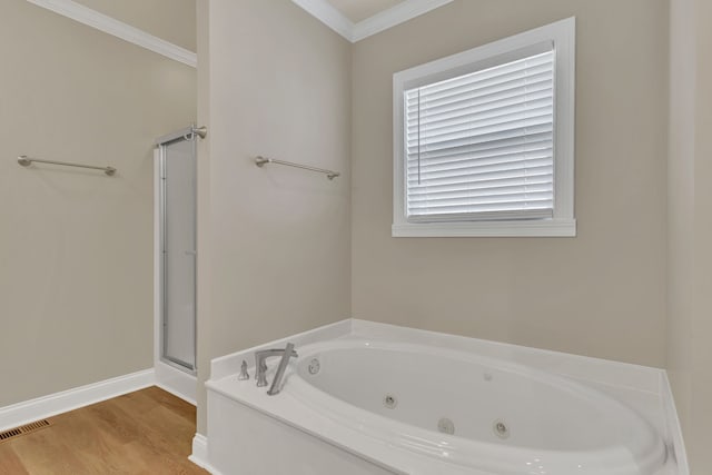 bathroom featuring ornamental molding, separate shower and tub, and wood-type flooring