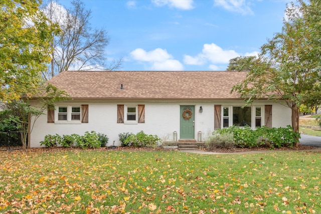 ranch-style home with a front lawn