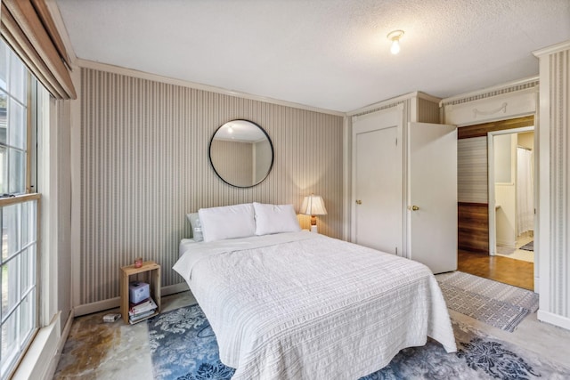 bedroom featuring baseboards and a textured ceiling
